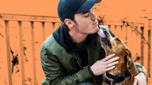 A man embracing his dog, seeking emotional support from the animal.