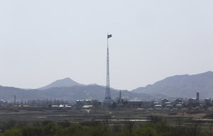 In this April 11, 2018 file photo, a North Korean flag flutters in the wind near the border villages of Panmunjom in Paju, South Korea.