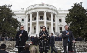 From left, Jim Acosta of CNN, Cecilia Vega of ABC News, and Major Garrett of CBS News, speak after President Donald Trump participated in an event on the South Lawn of the White House in Washington, Wednesday, Dec. 20, 2017, to acknowledge the final passage of tax cut legislation by congress.