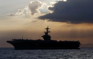 The U.S. aircraft carrier Theodore Roosevelt is anchored off Manila Bay to host top Philippine officials and businessmen in a cocktail reception Friday, April 13, 2018 west of Manila, Philippines.