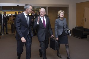 File - Defense Secretary James N. Mattis speaks with NATO Secretary General Jens Stoltenberg and Ambassador Kay Bailey Hutchison, the U.S. Ambassador to NATO at NATO headquarters in Brussels, Feb. 14, 2018