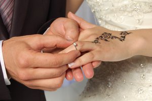 Wear engagement ring during wedding ceremony