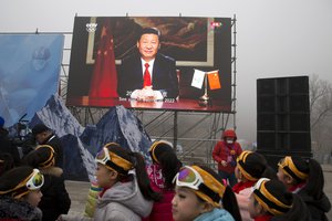 A pre-recorded greeting from Chinese President Xi Jinping is displayed on a screen during a ceremony to mark the arrival of the Olympic flag and start of the flag tour for the Winter Olympic Games Beijing 2022 at a section of the Great Wall of China on the outskirts of Beijing Tuesday, Feb. 27, 2018.