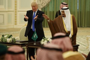 President Donald Trump and Saudi King Salam wave to the crowd during a signing ceremony at the Royal Court Palace, Saturday, May 20, 2017, in Riyadh.