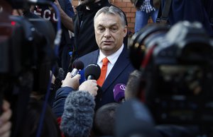 Hungary's prime minister Viktor Orban addresses the media outside a polling station in Budapest, Hungary, Sunday, April 8, 2018.