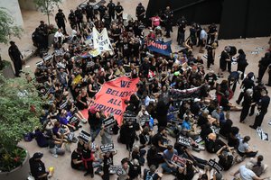 Protesters against Supreme Court nominee Brett Kavanaugh sit in the atrium of the Hart Senate Office Building on Capitol Hill in Washington, Thursday, Oct. 4, 2018.