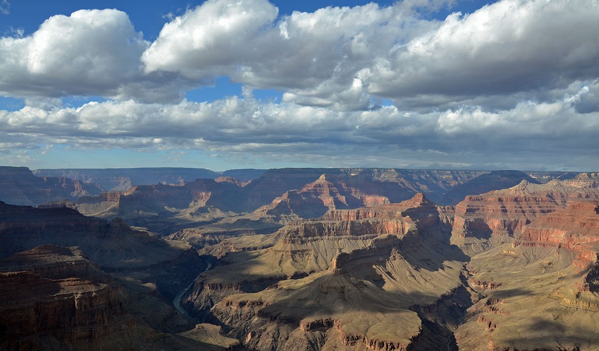 A wide shot of Grand Canyon, with clouds above.