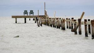 Two chairs attached to a dock mostly destroyed in the wake of Hurricane Harvey, Monday, Aug. 28, 2017, in Rockport, Texas. (AP Photo/Eric Gay)