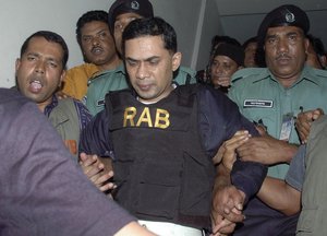 Bangladeshi security personnel escort Tarique Rahman, center, son of former Prime Minister Khaleda Zia and a senior leader of Zia's Bangladesh Nationalist Party, to a court in Dhaka, Bangladesh, Thursday, March 8, 2007.