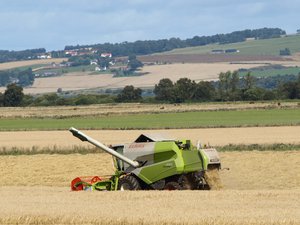 File - A combine harvester on a farm in Scotland.