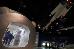 Visitors look at replicas of space crafts displayed at the China Science and Technology Museum in Beijing Sunday, Dec. 15, 2013