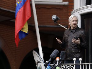 File - WikiLeaks founder Julian Assange gestures as he speaks on the balcony of the Ecuadorian embassy, in London, Friday May 19, 2017.