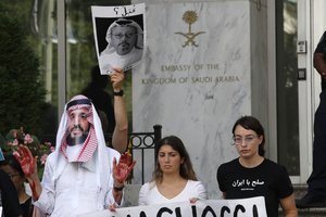 A sign of missing Saudi journalist Jamal Khashoggi is held up during a protest at the Embassy of Saudi Arabia about Khashoggi's disappearance, Wednesday, Oct. 10, 2018, in Washington.