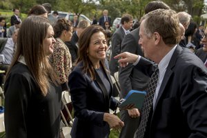 White House deputy national security adviser Dina Powell, center, accompanied by White House press secretary Sarah Huckabee Sanders, left, speaks with officials following a joint statement between President Donald Trump and Singapore's Prime Minister Lee Hsien in the Rose Garden at the White House, Monday, Oct. 23, 2017 in Washington.