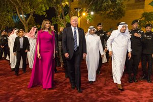 File - President Donald Trump and First Lady Melania Trump arrive to the Murabba Palace, escorted by King Salman bin Abdulaziz Al Saud of Saudi Arabia, Saturday evening, May 20, 2017, in Riyadh, Saudi Arabia, to attend a banquet in their honor.