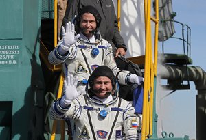 U.S. astronaut Nick Hague, right, and Russian cosmonaut Alexey Ovchinin, crew members of the mission to the International Space Station wave as they board the rocket prior to the launch of Soyuz-FG rocket at the Russian leased Baikonur cosmodrome, Kazakhstan, Thursday, Oct. 11, 2018.