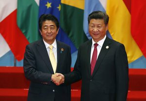 Japanese Prime Minister Shinzo Abe, left, poses with Chinaese President Xi Jinping for a photo before a group photo session for the G20 Summit in Hangzhou in eastern China's Zhejiang province, Sunday, Sept. 4, 2016. (AP Photo/Ng Han Guan)