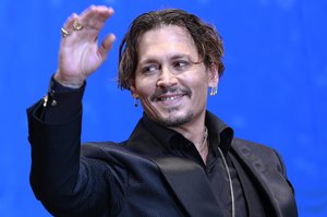 U.S. actor Johnny Depp waves for fans upon his arrival at the Japan premiere of his film "Pirates of the Caribbean: Dead Men Tell No Tales" in Tokyo, Tuesday, June 20, 2017.