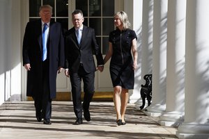 President Donald Trump, left, walks with American pastor Andrew Brunson, and his wife Norine Lyn