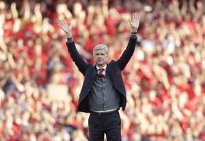 Arsenal's French manager Arsene Wenger waves to spectators after the match between Arsenal and Burnley at the Emirates Stadium in London, Sunday, May 6, 2018. The match is Arsenal manager Arsene Wenger's last home game in charge after announcing in April he will stand down as Arsenal coach at the end of the season after nearly 22 years at the helm.