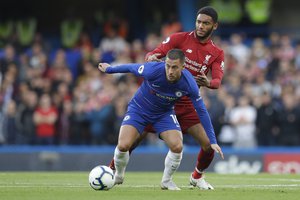 Chelsea's Eden Hazard, front, and Liverpool's Joe Gomez vie for the ball during the English Premier League soccer match between Chelsea and Liverpool at Stamford Bridge stadium in London, Saturday, Sept. 29, 2018.