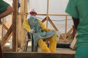 File - Joseph gives a thumbs up as he waits to be safely guided through the careful exit procedure from the "red zone" at the Makeni Ebola treatment centre in Sierra Leone.