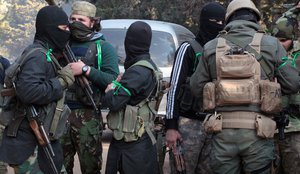 This photo released Feb .24, 2018 by the al-Qaida-affiliated Ibaa News Agency, that is consistent with independent AP reporting, purports to show al-Qaida-linked fighters from Hayat Tahrir al-Sham or Levant Liberation Committee, gathering in Idlib province, Syria.