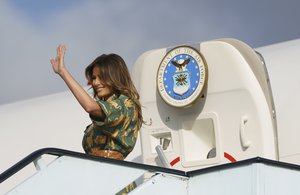 First lady Melania Trump waves as she boards a plane at Jomo Kenyatta International Airport in Nairobi, Kenya, Saturday, Oct. 6, 2018