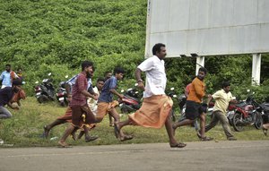 Police chase away protestors who tried to stop women of menstruating age from going to the Sabarimala temple at Nilackal, a base camp on way to the mountain shrine in Kerala, India, Wednesday, Oct. 17, 2018.