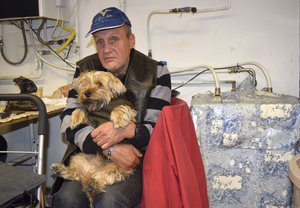 Ferenc Ribeny and his dog Mazli (Fluke) sit at a homeless shelter in Budapest, Hungary, Sunday Oct. 14, 2018.