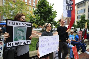 Protesters are gathered in front of the Alexandria Federal Court in Alexandria, Va., Tuesday, July 31, 2018, on day one of Paul Manafort's trial.