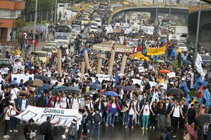 People march during a protest, organized by students, to ask for a higher budget for public universities in Bogota, Colombia, Wednesday, Oct. 10, 2018.