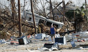 Ronnie Poole walks through destructions as he checks on a  friend's home in the aftermath of Hurricane Michael in Mexico Beach, Fla., Wednesday, Oct. 17, 2018. (AP Photo/Gerald Herbert)