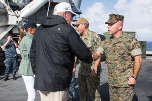 U.S. Navy Rear Adm. Jeff Hughes, left, commander, Expeditionary Strike Group 2, amphibious assault ship USS Kearsarge (LHD 3), and President Donald J. Trump, prepare to shake hands with Marines and Sailors during the president’s visit aboard the amphibious assault ship USS Kearsarge (LHD 3), Caribbean Sea, Oct. 3, 2017.