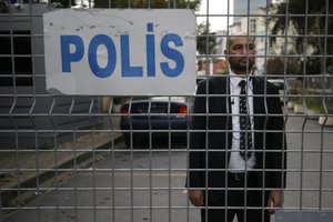 A security guard stands behind barriers blocking the road leading to Saudi Arabia's consulate in Istanbul, Saturday, Oct. 20, 2018.