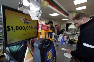 A sign displays the estimated Mega Millions jackpot at a convenience store in Chicago, Friday, Oct. 19, 2018