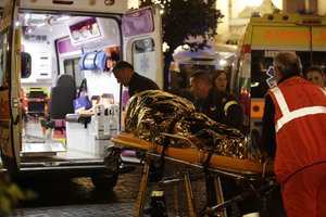 Rescuers evacuate a person who was wounded after an escalator at the "Repubblica" subway station in Rome, started running much too fast before crashing, Tuesday, Oct. 23, 2018.