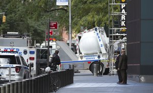 An NYPD bomb squad vehicle departs after police personnel removed an explosive device from Time Warner Center Friday, Oct. 24, 2018, in New York. (AP Photo/Kevin Hagen).