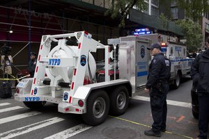 A police truck tows a total containment vessel to a post office in midtown Manhattan to dispose of a suspicious package, Friday, Oct. 26, 2018, in New York.