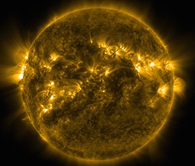 File - Bright spots and illuminated arcs of solar material hovering in the sun's atmosphere highlight what's known as active regions on the sun, in this image from NASA's Solar Dynamics Observatory, captured on April 20, 2015.