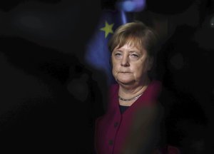 German Chancellor Angela Merkel listens Czech Republic's Prime Minister Andrej Babis during a press conference after talks in Prague, Friday, Oct. 26, 2018