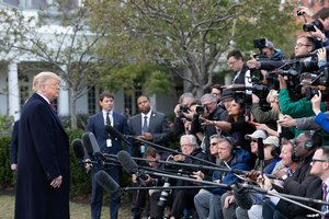 President Donald J. Trump talks with reporters along the South Lawn of the White House Wednesday, Oct. 31, 2018, prior to boarding Marine One to begin his trip to Fort Myers, Fla.