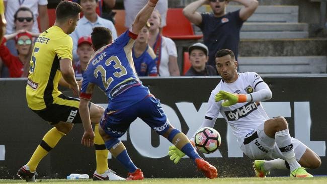 Paul Izzo of Central Coast Mariners makes a save from a Devante Clut.