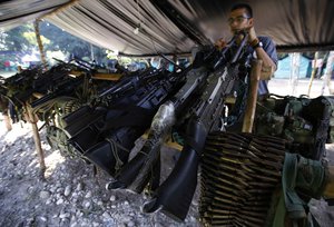 In this Feb. 28, 2017 file photo, Weapons belonging to rebels of the Revolutionary Armed Forces of Colombia, FARC, are stored at a rebel camp in La Carmelita near Puerto Asis in Colombia's southwestern state of Putumayo.