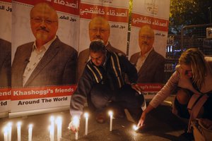 Activists protesting the killing of Saudi journalist Jamal Khashoggi hold a candlelight vigil outside Saudi Arabia's consulate in Istanbul, Thursday, Oct. 25, 2018