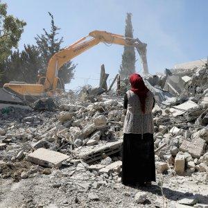 Fawzia stands on the ruins of her house, after her Palestinian ex-husband demolished the dwelling to not face the prospect of Israeli settlers moving in after he lost a land ownership case in Israeli courts, in the East Jerusalem neighbourhood of Beit Hanina, July 19, 2018. REUTERS/Ammar Awad