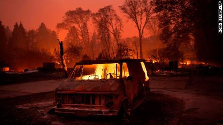 Flames burn inside a van as the Camp Fire tears through Paradise, Calif., on Thursday, Nov. 8, 2018. Tens of thousands of people fled a fast-moving wildfire Thursday in Northern California, some clutching babies and pets as they abandoned vehicles and struck out on foot ahead of the flames that forced the evacuation of an entire town and destroyed hundreds of structures. (AP Photo/Noah Berger)