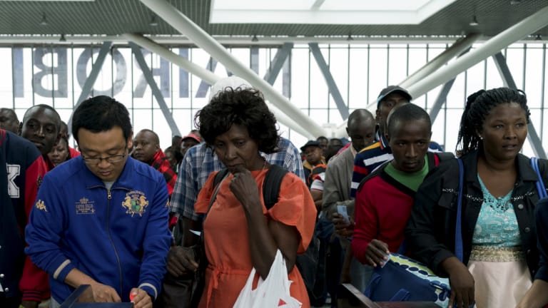 Chinese employees help passengers at the new Standard Gauge Railway terminal in Nairobi, Kenya.