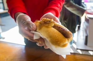 There is no government regulation that demands you wear gloves when handling food.