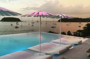 An infinity pool at Kata Rocks resort overlooks yachts moored in the Andaman Sea below.